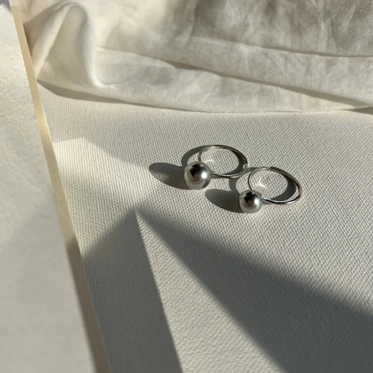 Elegant women's jewelry showing an adjustable pearl ring crafted from sterling silver.