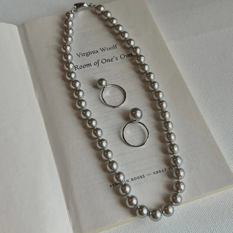 Hand modeling a women's elegant adjustable pearl ring, sterling silver with a freshwater pearl.