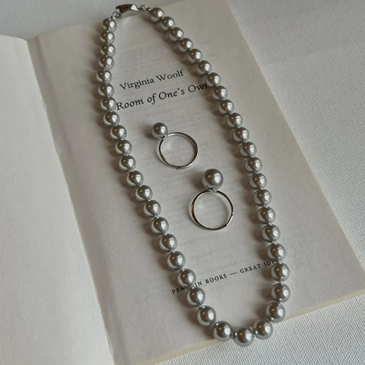 Hand modeling a women's elegant adjustable pearl ring, sterling silver with a freshwater pearl.