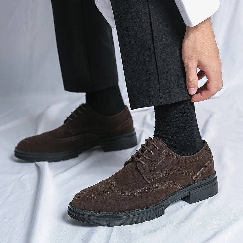 Premium men's suede brogue shoes. Elegant dress footwear in black, featuring classic perforations and comfort.