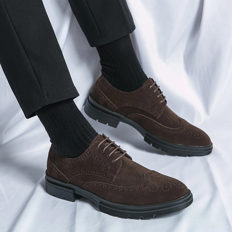 Detailed view of men's brown suede brogues, showcasing the classic perforations and high-quality finish.
