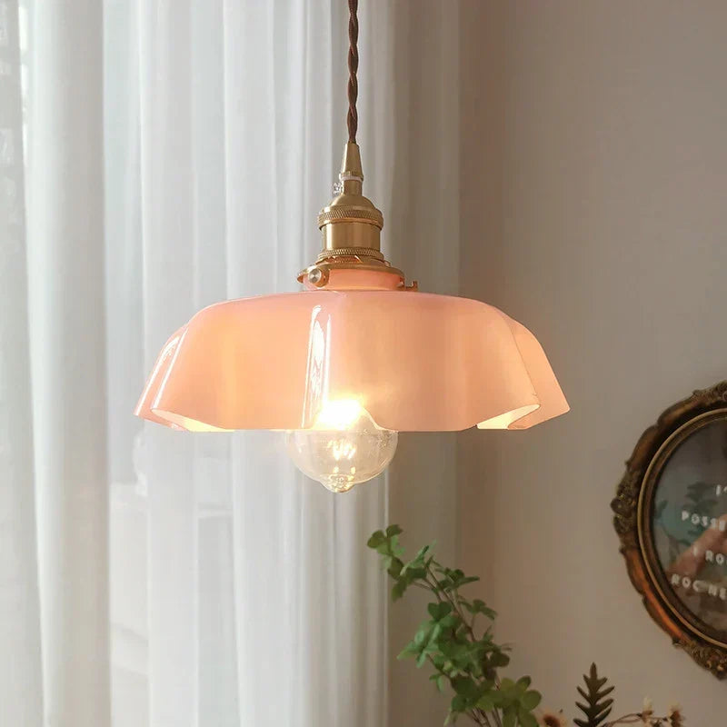 Stylish kitchen island brass hanging lamp, casting warm light, perfect for French decor ambiance.