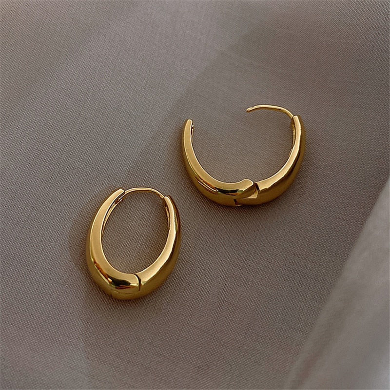 Elegant women's classic gold hoop earrings, a versatile and timeless accessory for any outfit and occasion.