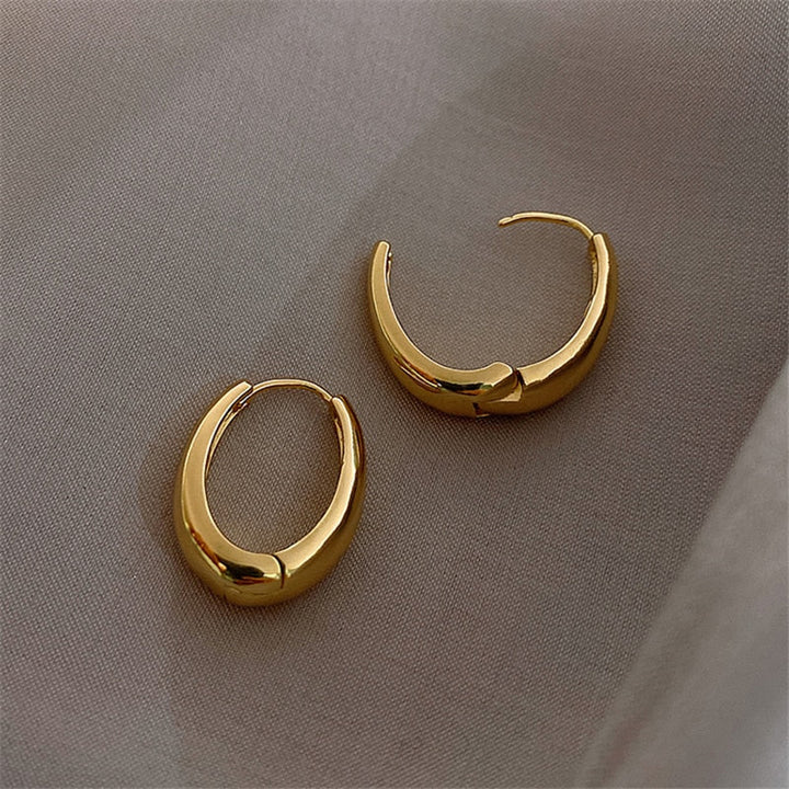 Elegant women's classic gold hoop earrings, a versatile and timeless accessory for any outfit and occasion.
