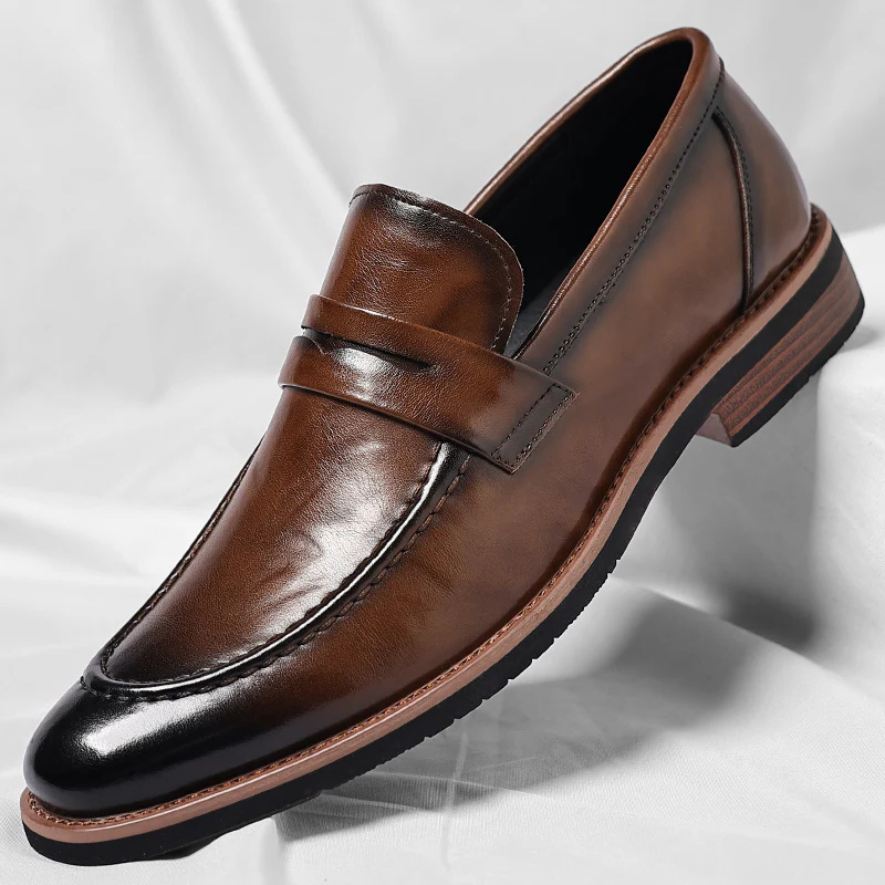 Classic men's brown penny loafers, slip-on style for comfort & versatility, ideal for casual or dress.