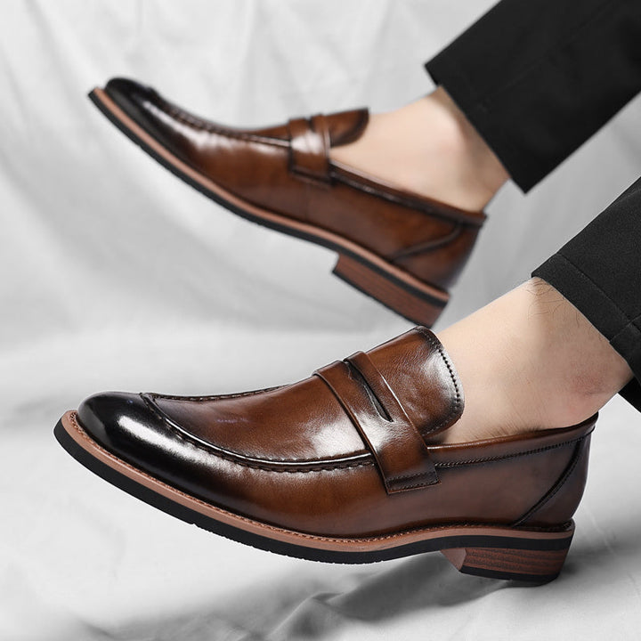 Men's dressy brown penny loafers, a versatile slip-on shoe for office or smart casual outfits.