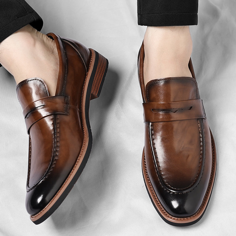 Stylish black slip-on penny loafers for men, offering easy wear and classic, comfortable design.