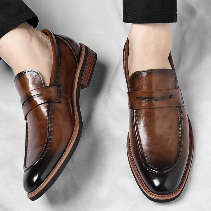 Stylish black slip-on penny loafers for men, offering easy wear and classic, comfortable design.