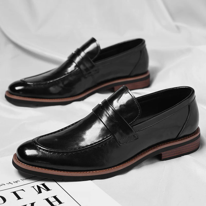 Timeless men's black penny loafers, featuring a comfortable slip-on design for ultimate convenience.