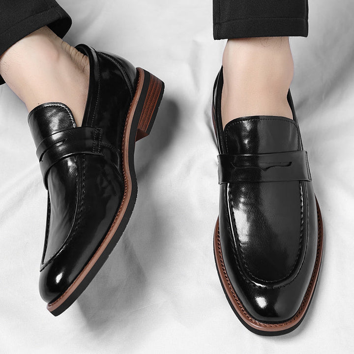 Sophisticated men's slip-on penny loafers, a classic choice for modern casual or dress looks.