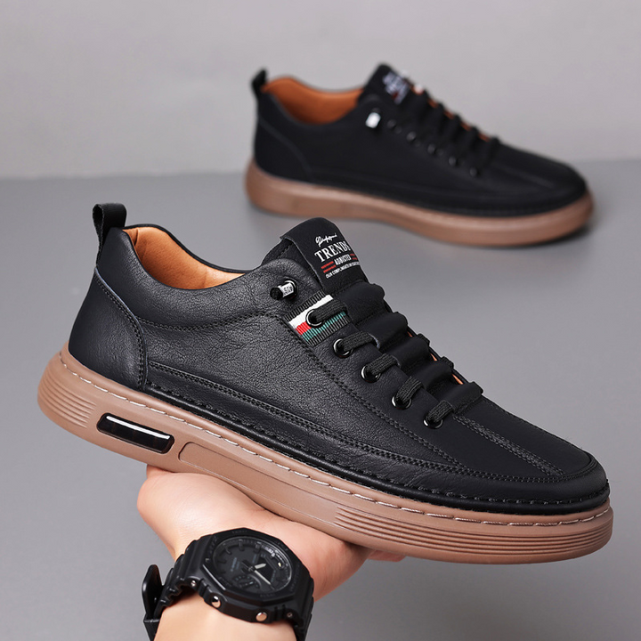 Classic men's low-top lace-up sneakers in brown, white & black. Comfortable casual shoes for everyday fashion.
