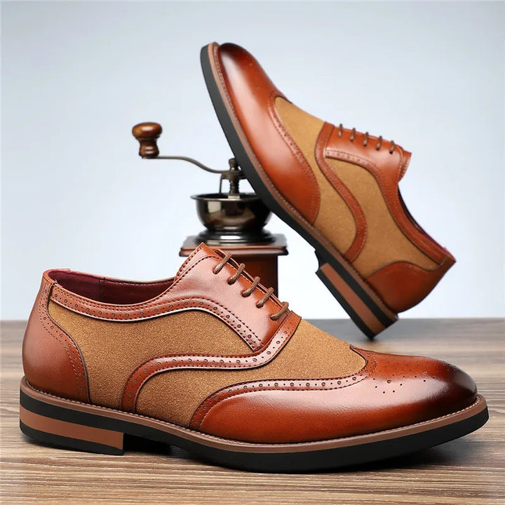 Elegant men's two-tone brogue oxfords with contrasting colors, perfect for a refined style.