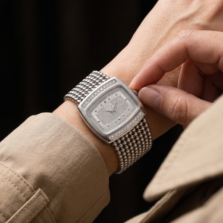 Close-up of a classic elegant unisex watch, highlighting the clean dial and metal band. Versatile accessory.