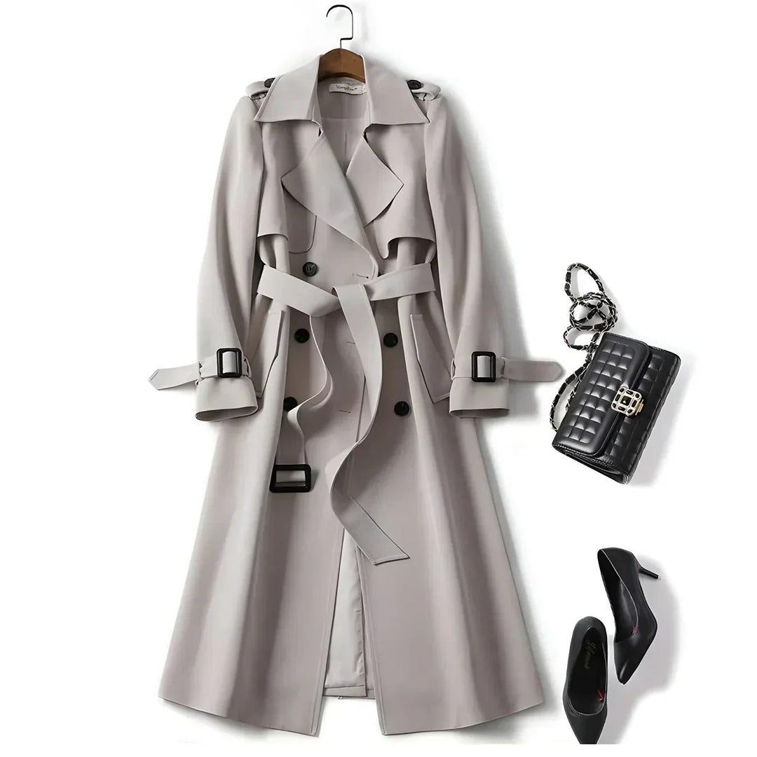 Long women's trench coat, belted and double-breasted, providing water-resistant protection for all seasons.