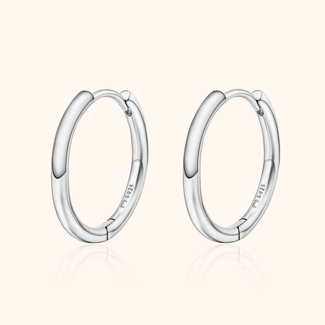Classic women's sterling silver hoop earrings, perfect for everyday wear. Elegant and versatile jewelry.