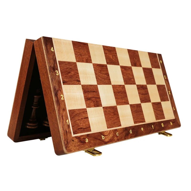 Open classic wooden chess set ready for play on its rich walnut foldable board. A premium board game.