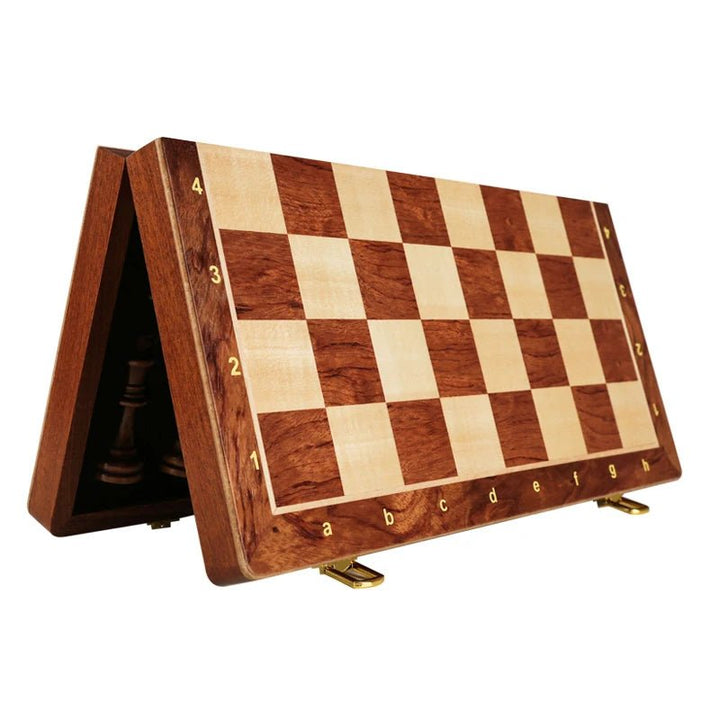Open classic wooden chess set ready for play on its rich walnut foldable board. A premium board game.