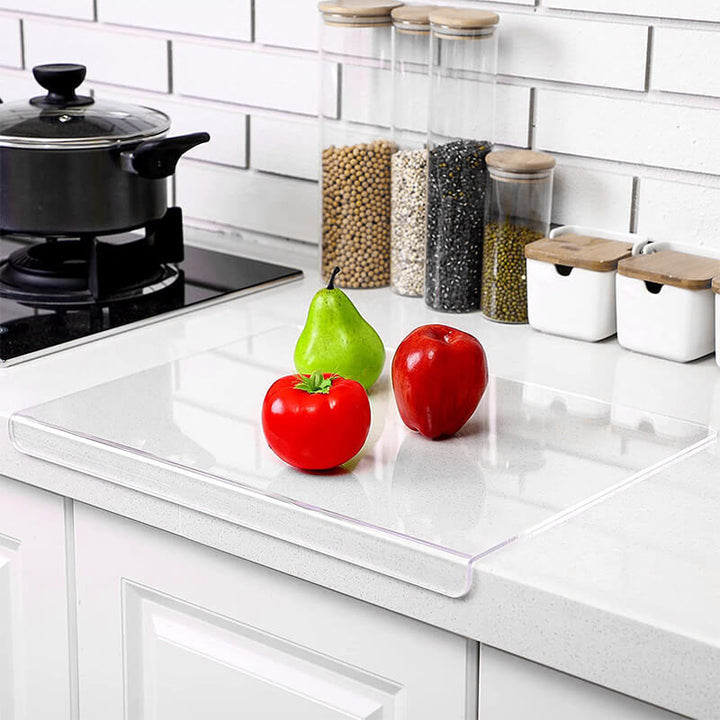 Modern clear acrylic non-slip chopping board; ideal for hygienic food prep in contemporary kitchens.