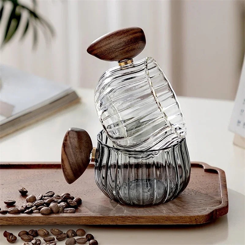 Modern borosilicate glass mug with wood handle, a stylish and practical gift for coffee/tea lovers.