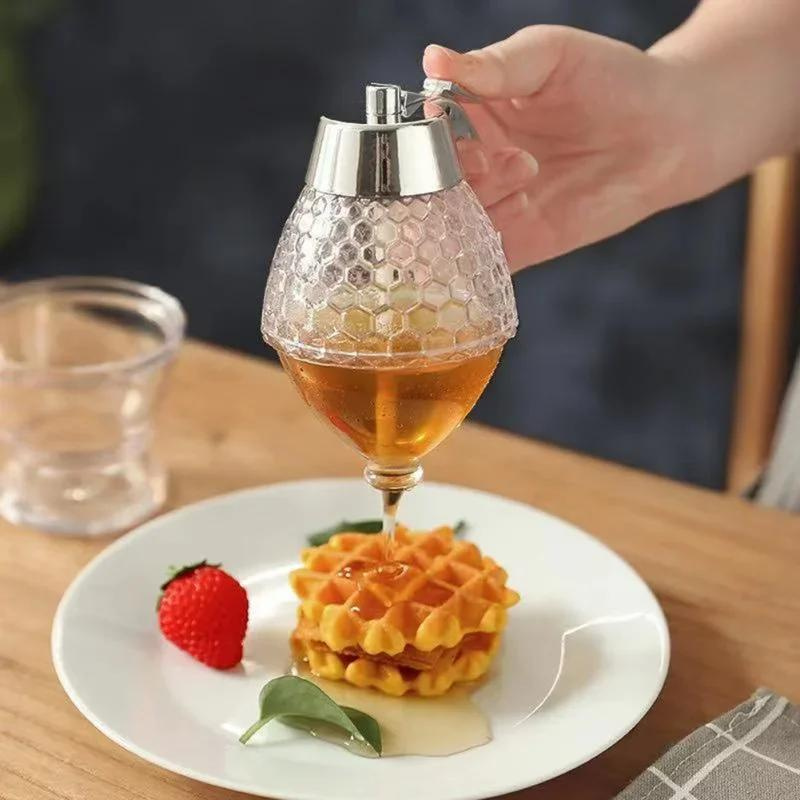 Drip-free plastic honey dispenser with clear design & stand, a convenient kitchen tool for mess-free syrup serving.