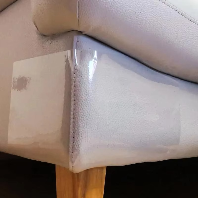 Self-adhesive clear cat scratch protector shield for furniture, keeping sofas safe from pets.