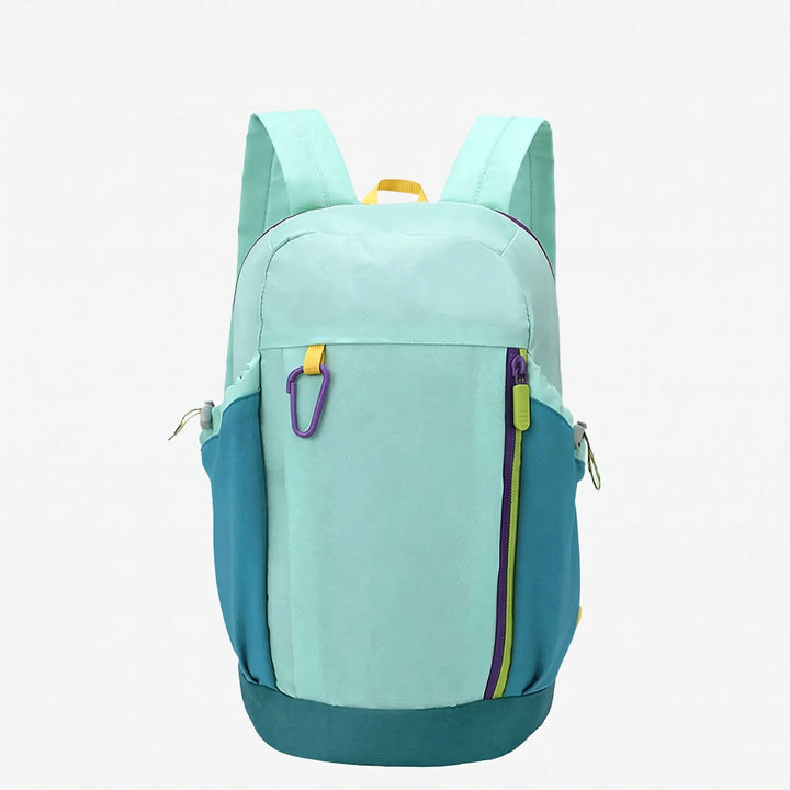 Model wearing a grey unisex hiking backpack on a mountain, emphasizing comfort & adventure.