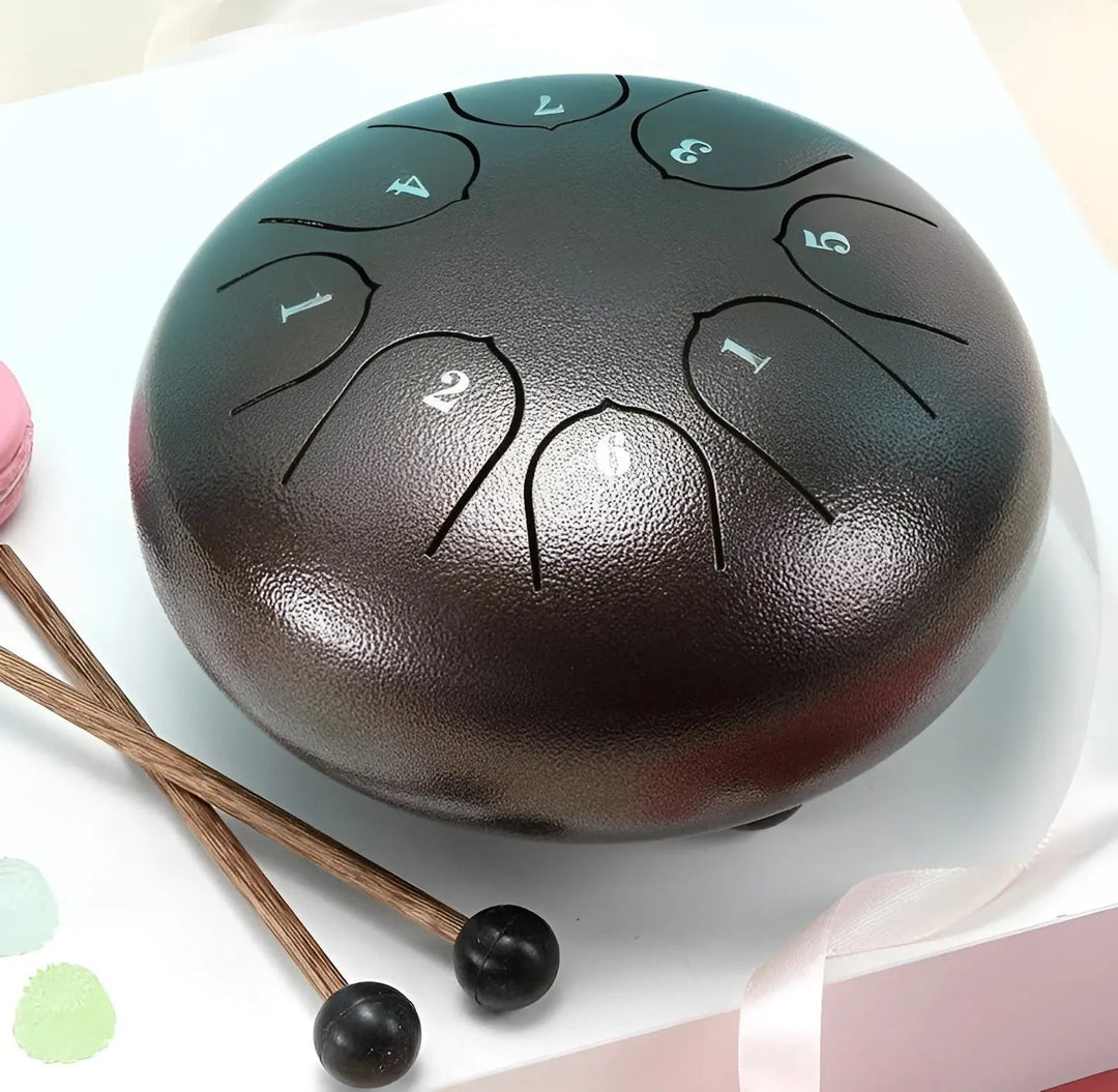 Close-up of a carbon steel tongue drum with mallets, perfect for meditation & relaxation.