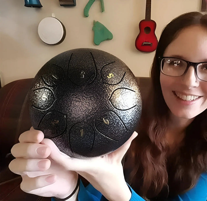 Soothing steel tongue drum in use, enhancing focus and relaxation during meditation.