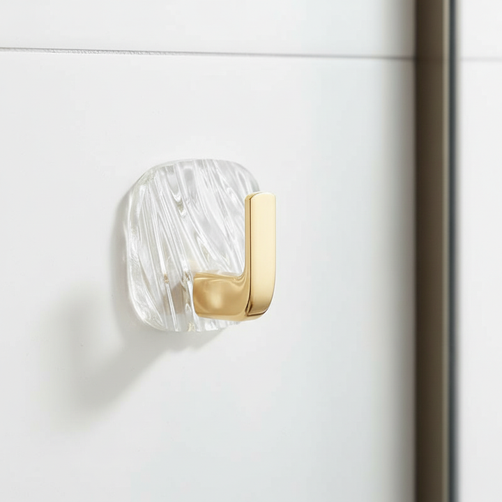 Close-up of a clear acrylic self-adhesive wall hook, showcasing its transparent design and strong adhesive back