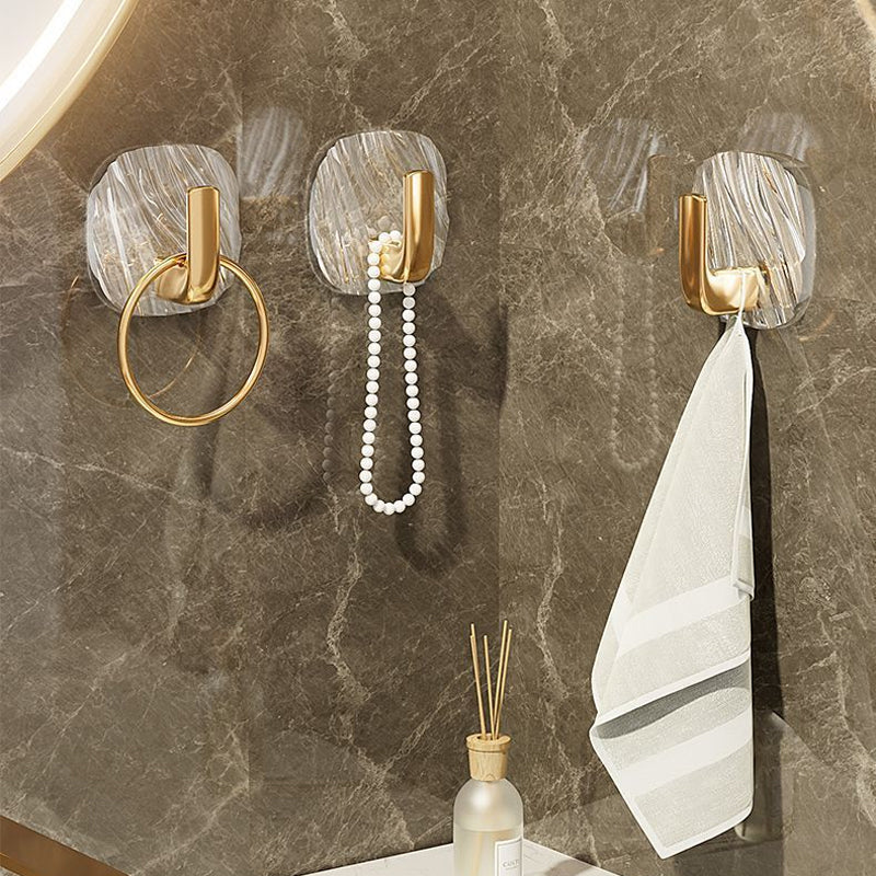 Lifestyle image of a clear acrylic wall hook holding a small bath towel, highlighting its use in bathroom decor