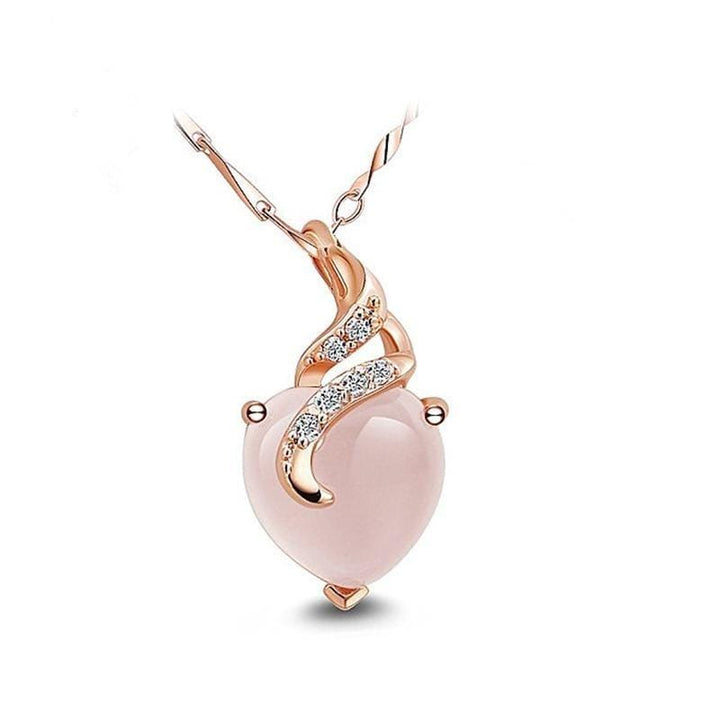 Side view of elegant women's silver opal heart necklace, showing detailed Calista craftsmanship.
