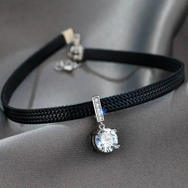 Close-up of elegant women's geometric crystal necklace with sparkling facets, a modern fashion accessory.