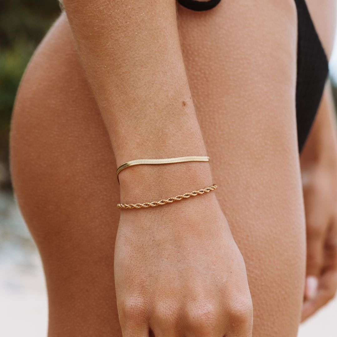 Shimmering silver herringbone bracelet for women, a stylish and adjustable jewelry piece.