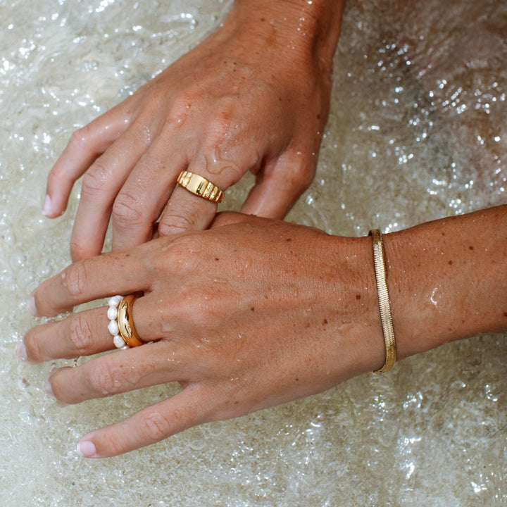 Stackable herringbone chain bracelet in gold, a chic jewelry gift for her.