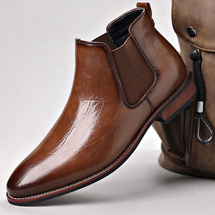 Close-up of polished black men's slip-on Chelsea boots, perfect for dress or casual wear.