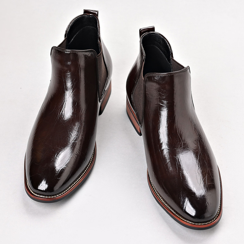 Detail of the elastic side panel on men's black polished slip-on Chelsea boots for comfort.