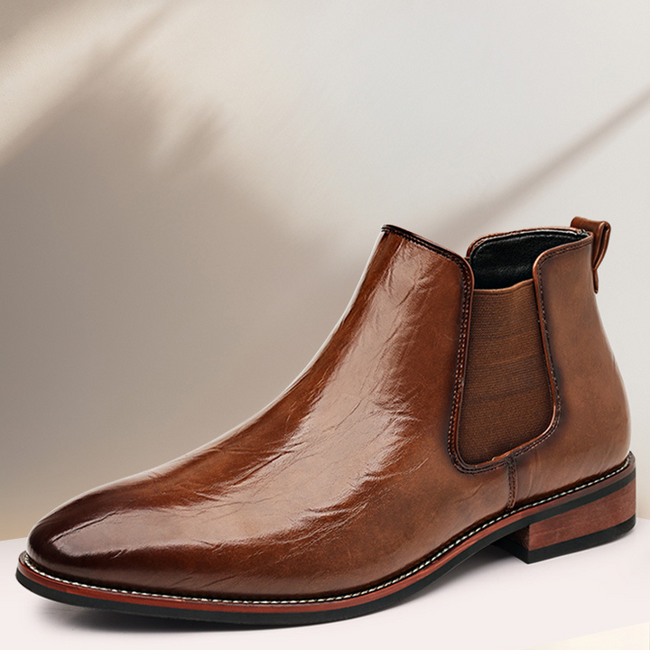 Side view of men's sleek black slip-on ankle boots, ideal for smart casual or formal outfits.