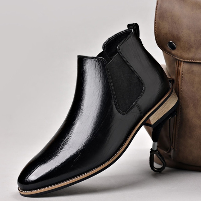 Men's polished brown Chelsea boots with elastic goring, designed for easy slip-on comfort.