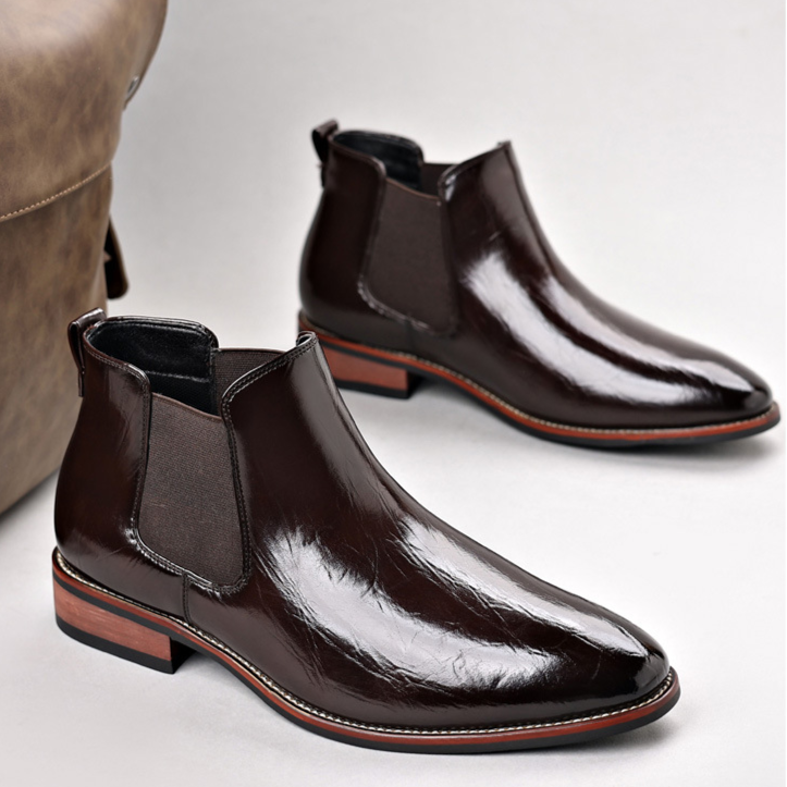 High-angle shot of men's durable slip-on ankle boots, featuring a polished finish.