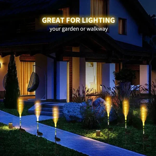 Elegant reed-style solar garden lights casting soft glow in outdoor space.