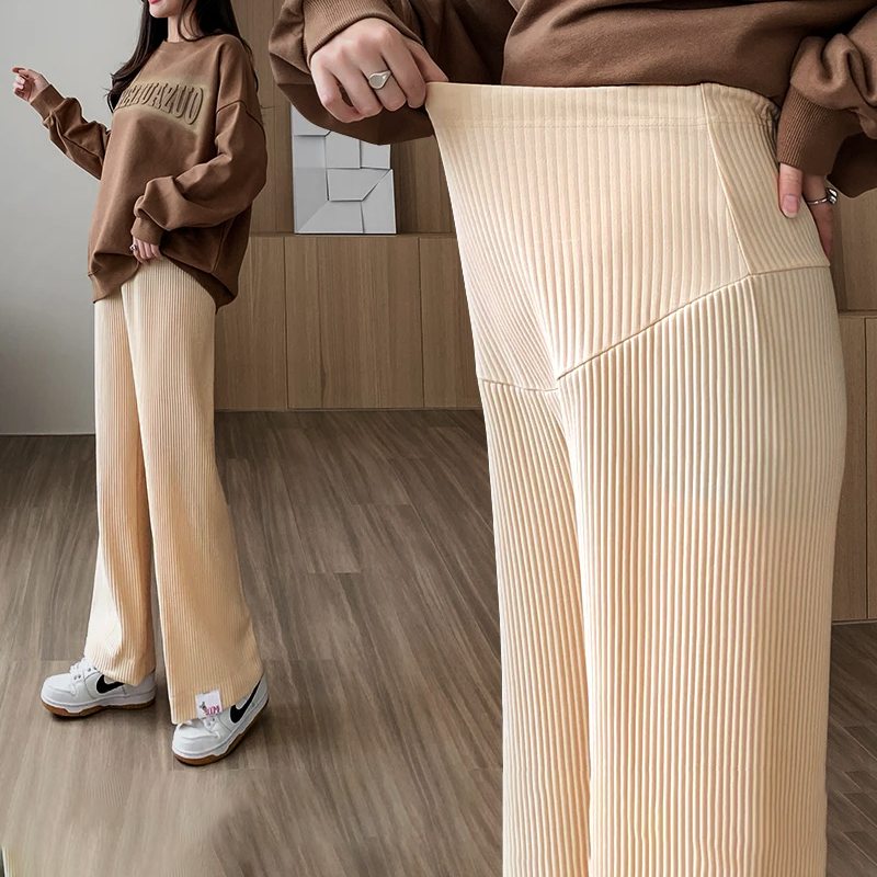 Close-up of stretchy fabric & wide-leg design of women's comfortable maternity pants for pregnancy.