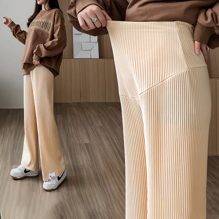 Close-up of stretchy fabric & wide-leg design of women's comfortable maternity pants for pregnancy.