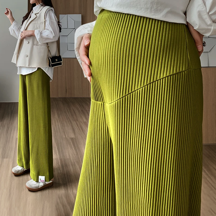 Full shot of an expectant mother wearing stylish, high-waisted maternity pants for casual comfort.