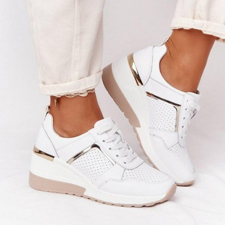 Pair of stylish women's sneakers with advanced orthopaedic features for ultimate comfort.