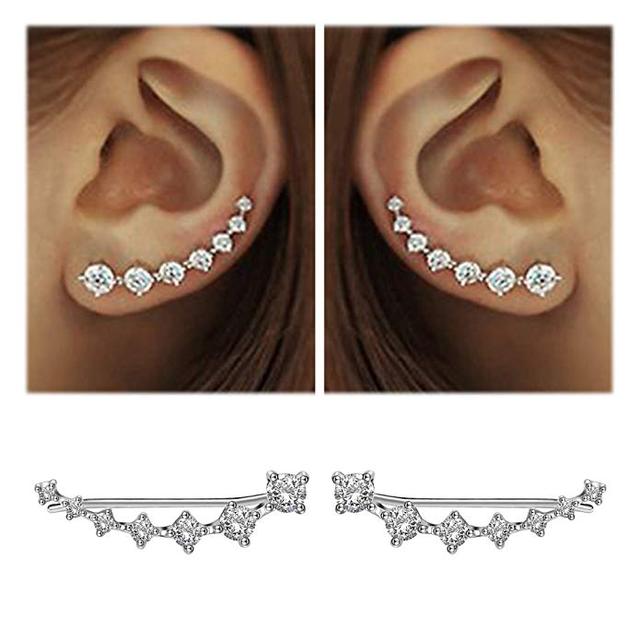 Close-up of women's sparkling dangle earrings, sterling silver, elegant gemstone drops.