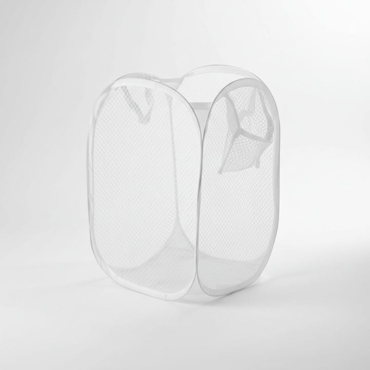 Collapsible mesh laundry hamper holding a load of clothes, demonstrating its capacity.