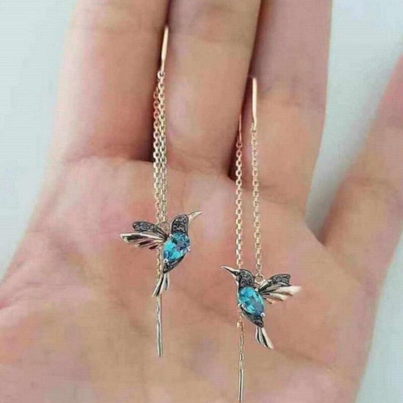 Elegant women's enamel hummingbird dangle earrings, featuring vibrant colors and shimmering zirconia accents.