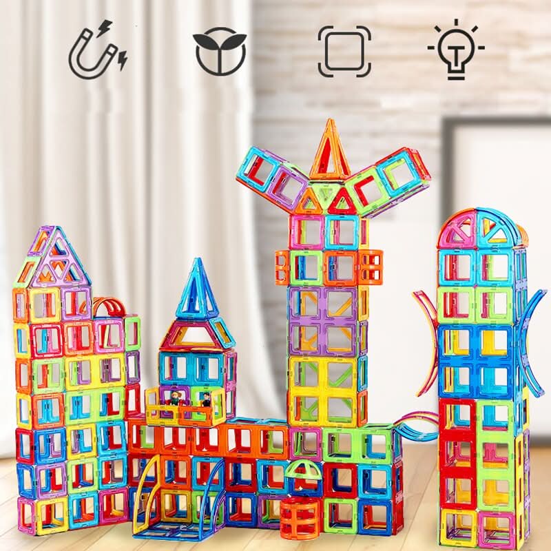 Young child happily building a tall tower with colorful magnetic building blocks, enhancing fine motor skills & creativity.