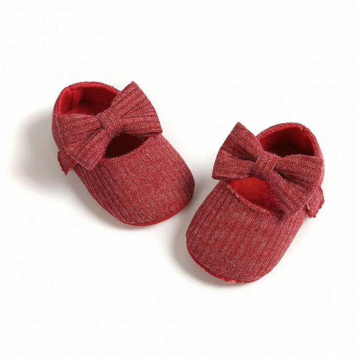 Baby wearing comfortable first step shoes, demonstrating secure fit & support for walking practice.