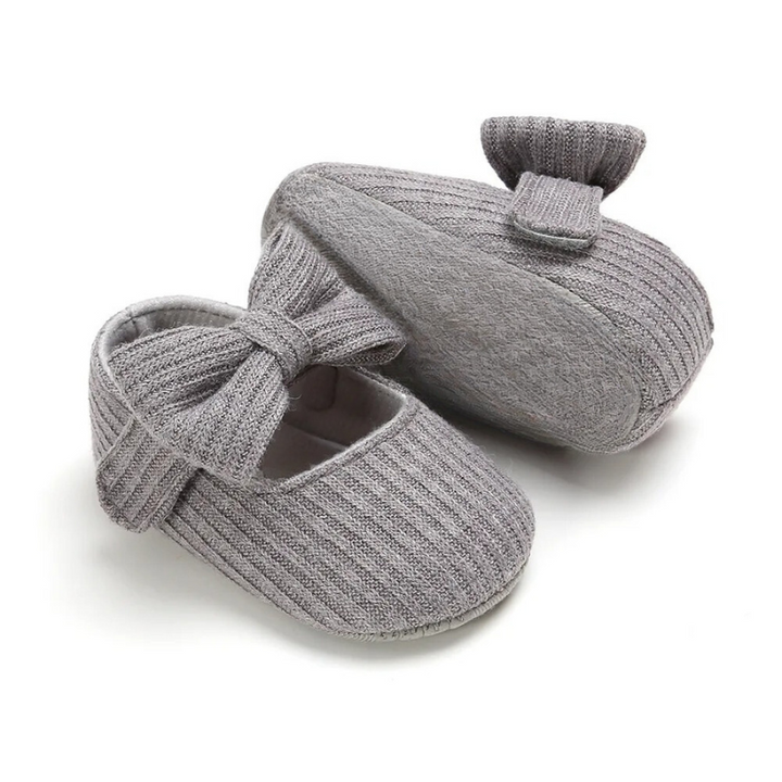 Close-up of soft-material baby first step shoes, highlighting flexible sole for ultimate infant comfort.